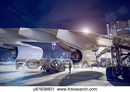 Stock Image - Ground crew refuelling A380 aircraft at airport. Fotosearch