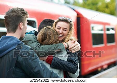 Group of friends hugging at railway station, smiling View Large Photo Image Stock Image - Group of friends hugging at railway station, smiling. Fotosearch