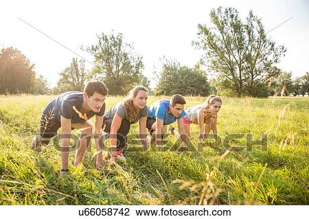 Group of friends in field, in starting position, about to race View Large Photo Image Stock Image - Group of friends in field, in starting position, about to race. Fotosearch