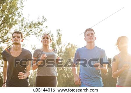Group of friends running outdoors in rural environment View Large Photo Image Stock Photography - Group of friends running outdoors in rural environment. Fotosearch