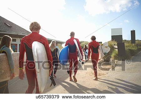 Group of surfers, heading towards beach, carrying surfboards View Large Photo Image Stock Photo - Group of surfers, heading towards beach, carrying surfboards. Fotosearch