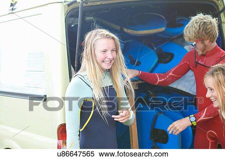 Group of surfers standing beside van, getting ready to surf View Large Photo Image Stock Photography - Group of surfers standing beside van, getting ready to surf. Fotosearch