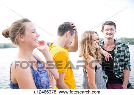 Stock Photo - Group of young adults, outdoors, laughing. Fotosearch