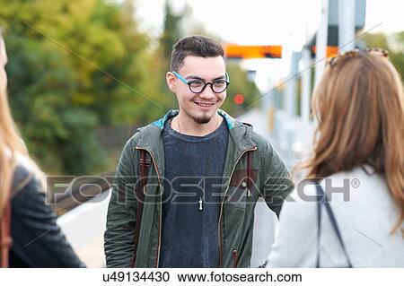 Group of young adults standing on railway platform View Large Photo Image Stock Image - Group of young adults standing on railway platform. Fotosearch