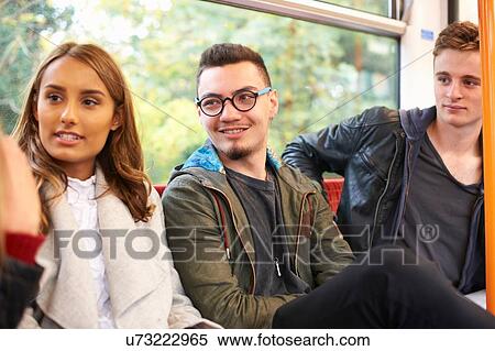 Group of young friends on train journey View Large Photo Image Stock Photography - Group of young friends on train journey. Fotosearch