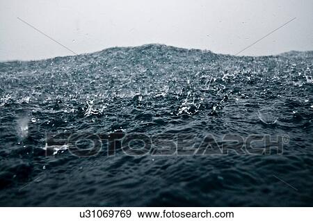 Heavy raindrops hitting surface of ocean, Cocos Island, Costa Rica View Large Photo Image Stock Photo - Heavy raindrops hitting surface of ocean, Cocos Island, Costa Rica. Fotosearch