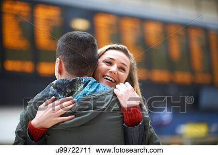 Heterosexual couple hugging at railway station, rear view View Large Photo Image Stock Image - Heterosexual couple hugging at railway station, rear view. Fotosearch
