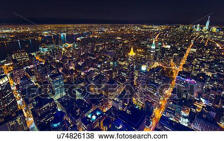 High angle cityscape of Manhattan financial district and One World Trade Centre at night, New York, USA View Large Photo Image Stock Photo - High angle cityscape of Manhattan financial district and One World Trade Centre at night, New York, USA. Fotosearch