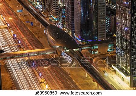 Stock Photo - High angle view of city highway and Dubai metro rail station at night, downtown Dubai, United Arab Emirates. Fotosearch