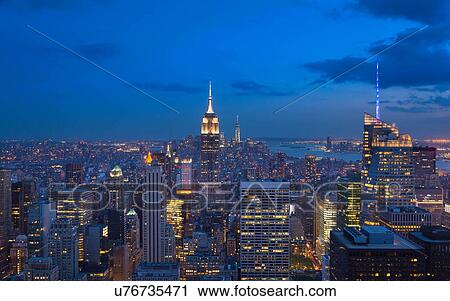 Stock Image - High angle view of midtown Manhattan and Empire State Building at night, New York, USA. Fotosearch