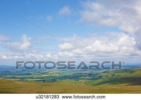 Stock Image - High angle view of rural landscape and blue cloudy sky, Cumbria, UK. Fotosearch