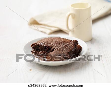 Stock Image - Hot chocolate fudge pudding on white washed wood. Fotosearch