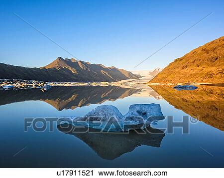 Stock Image - Ice on lake at sunset, Heinabergsjokull Glacier, Iceland. Fotosearch