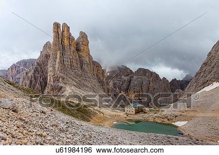Industrial building and lake in valley, Dolomites, Italy View Large Photo Image Stock Photograph - Industrial building and lake in valley, Dolomites, Italy. Fotosearch