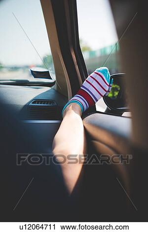Leg with colourful striped socks on car window View Large Photo Image Stock Image - Leg with colourful striped socks on car window. Fotosearch