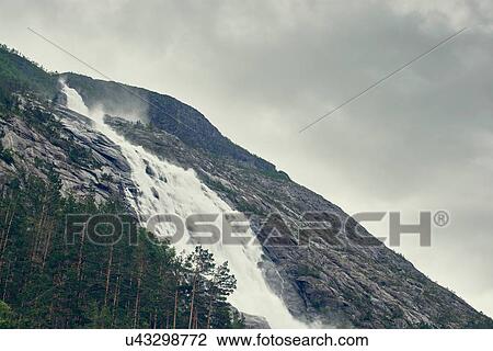 Stock Image - Low angle view of Langfoss, Etne, Norway. Fotosearch