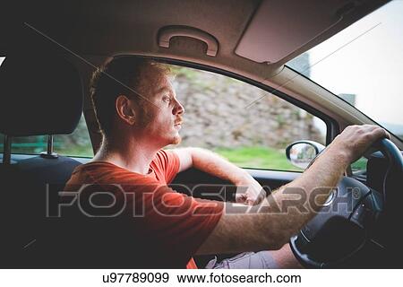 Stock Photo - Man driving, Garda, Italy. Fotosearch