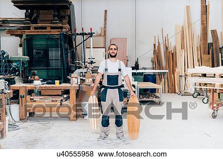 Man in workshop with skateboards View Large Photo Image Stock Photo - Man in workshop with skateboards. Fotosearch