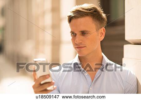 Man texting in street, close up View Large Photo Image Stock Photo - Man texting in street, close up. Fotosearch