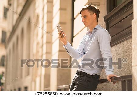 Man using phone, London, UK View Large Photo Image Stock Image - Man using phone, London, UK. Fotosearch