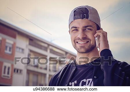 Stock Photo - Man using smartphone, Cagliari, Sardinia, Italy. Fotosearch
