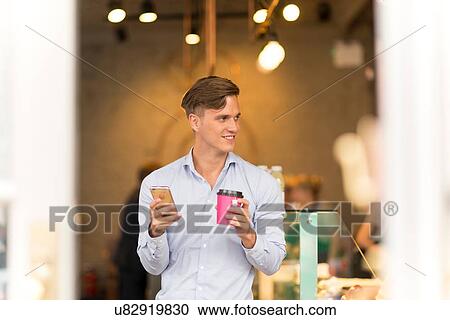 Man with takeaway coffee using smartphone View Large Photo Image Stock Image - Man with takeaway coffee using smartphone. Fotosearch