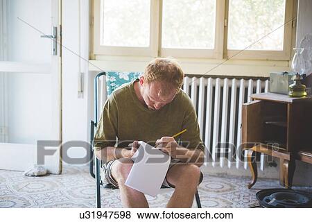 Man writing notes in room View Large Photo Image Stock Photo - Man writing notes in room. Fotosearch