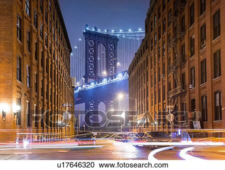 Stock Image - Manhattan Bridge and city apartments at night, New York, USA. Fotosearch