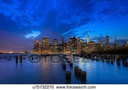 Stock Photography - Manhattan financial district skyline and One World Trade Centre at dusk, New York, USA. Fotosearch
