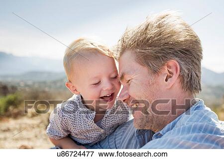 Mature man and toddler daughter laughing, Calvi, Corsica, France View Large Photo Image Stock Photo - Mature man and toddler daughter laughing, Calvi, Corsica, France. Fotosearch