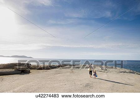 Mature man strolling with his toddler daughter on beach, Calvi, Corsica, France View Large Photo Image Stock Image - Mature man strolling with his toddler daughter on beach, Calvi, Corsica, France. Fotosearch