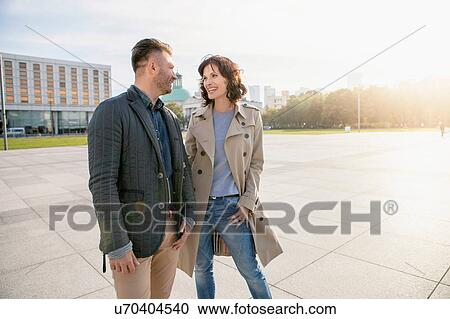 Mid adult couple in town square View Large Photo Image Stock Image - Mid adult couple in town square. Fotosearch