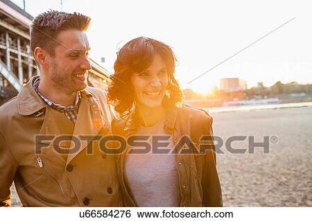 Stock Photograph - Mid adult couple smiling. Fotosearch