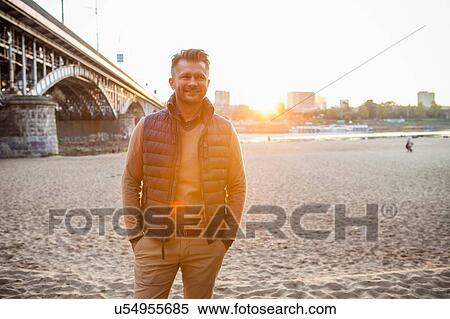 Stock Photography - Mid adult man by bridge, Warsaw, Poland. Fotosearch