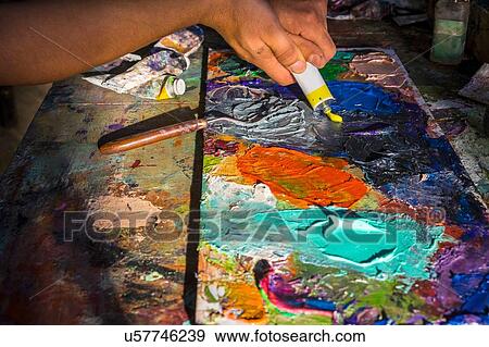 Stock Photo - Mid adult man, creating artwork, close-up. Fotosearch