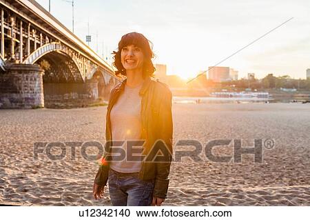 Stock Image - Mid adult woman by bridge, Warsaw, Poland. Fotosearch