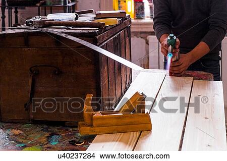 Mid section of mid adult man using blow torch on timber plank View Large Photo Image Picture - Mid section of mid adult man using blow torch on timber plank. Fotosearch