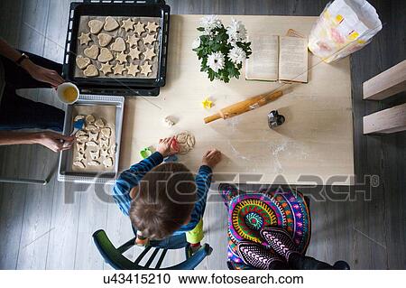 Mother and son making cookies, overhead view View Large Photo Image Stock Image - Mother and son making cookies, overhead view. Fotosearch
