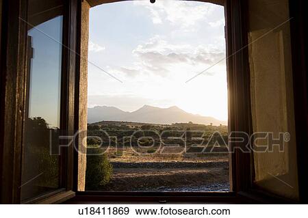 Stock Photo - Open window view of rural landscape at dusk, Calvi, Corsica, France. Fotosearch