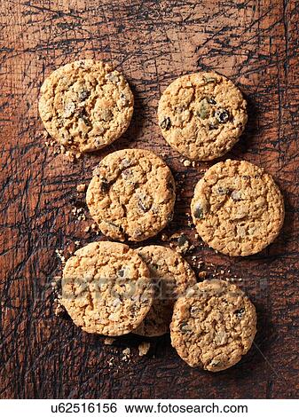 Overhead view of chocolate chip, fruit, nut and seed cookies on scratched wood View Large Photo Image Stock Photograph - Overhead view of chocolate chip, fruit, nut and seed cookies on scratched wood. Fotosearch