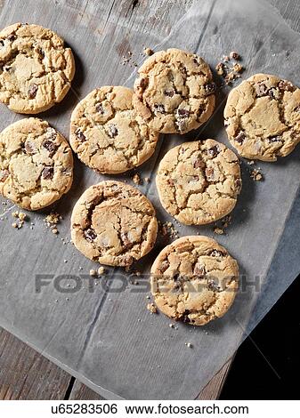 Stock Photograph - Overhead view of chocolate chunk cookies on greaseproof paper. Fotosearch