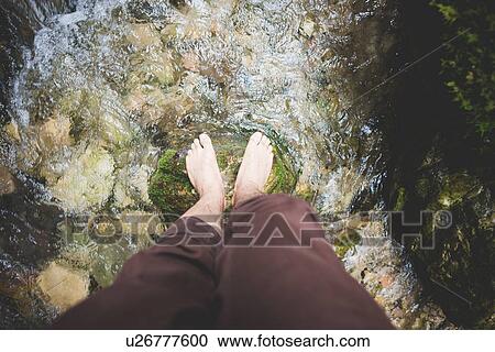Overhead view of legs standing on rock in stream View Large Photo Image Stock Image - Overhead view of legs standing on rock in stream. Fotosearch