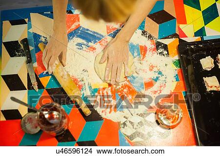Overhead view of womans hands flattening dough at kitchen table View Large Photo Image Picture - Overhead view of womans hands flattening dough at kitchen table. Fotosearch