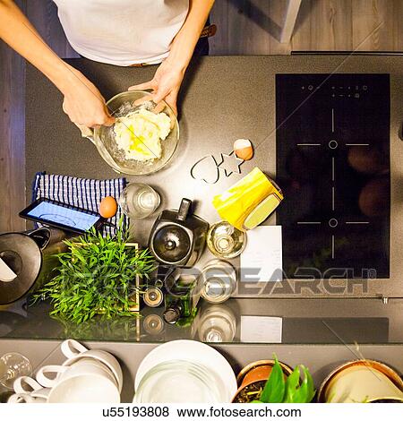 Overhead view of womans hands stirring eggs in mixing bowl View Large Photo Image Stock Photo - Overhead view of womans hands stirring eggs in mixing bowl. Fotosearch