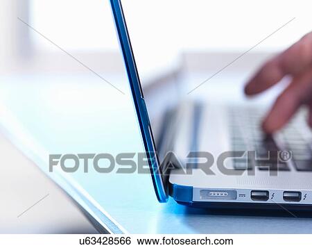 Person using laptop, close up View Large Photo Image Stock Photograph - Person using laptop, close up. Fotosearch