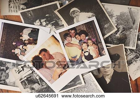 Pile of family photographs on table, overhead view View Large Photo Image Stock Image - Pile of family photographs on table, overhead view. Fotosearch