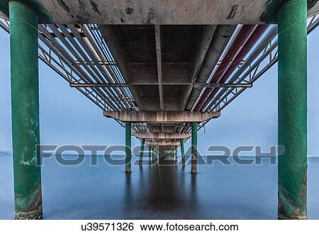 Stock Photograph - Pipes going across ocean, Cagliari, Sardinia, Italy. Fotosearch