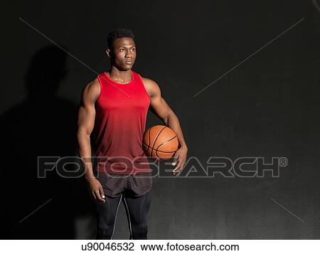 Portrait of basketball player with ball, black background View Large Photo Image Stock Image - Portrait of basketball player with ball, black background. Fotosearch