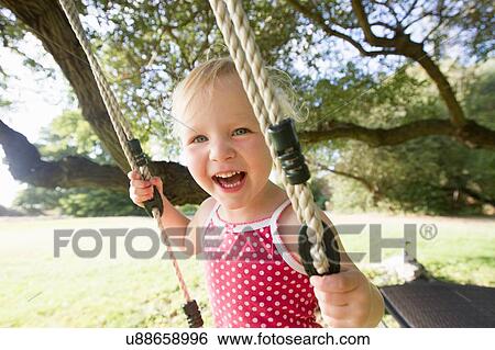 Portrait of female toddler on tree swing View Large Photo Image Stock Photograph - Portrait of female toddler on tree swing. Fotosearch