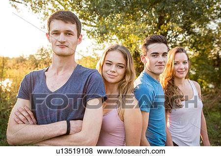 Stock Photo - Portrait of group of friends in rural environment, smiling. Fotosearch